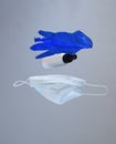 Levitating Epidemic Protective kit, Masks pile, gloves and alcohol hand sanitizer bottle on gray background