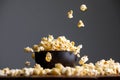 Levitating falling popcorn in a ceramic bowl and around it.