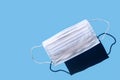 Levitating medical face mask on blue background. Horizontal banner, poster with copy space. White disposable surgical textile mask