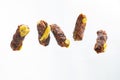 Levitating mici or mitititei (traditional romanian food) with mustard on white background Royalty Free Stock Photo