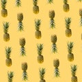 Levitating natural organic pineapples summer concept. Creative pattern made of many fresh exotic ananas against illuminated yellow Royalty Free Stock Photo