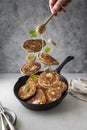 Levitating pancakes in frying, skillet pan with honey,banana, butter and mint leaves, breakfast