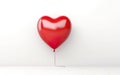 Levitating red heart shaped latex balloon isolated on white background. Royalty Free Stock Photo