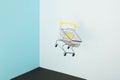 Levitating shopping cart on blue background. Safe online shopping on quarantine concept. Flying Empty supermarket