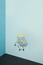 Levitating shopping cart on blue background. Safe online shopping on quarantine concept. Flying Empty supermarket