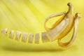 Levitating sliced banana on a yellow background.