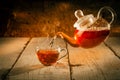 Levitating teapot pouring hot tea into a glass