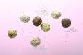 Levitating Vegan Sweets, Delicious Candy Balls with seeds, nuts and dried fruit, Healthy Candies on Pink Background Royalty Free Stock Photo