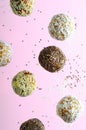 Levitating Vegan Sweets, Delicious Candy Balls with seeds, nuts and dried fruit, Healthy Candies on Pink Background Royalty Free Stock Photo