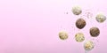 Levitating Vegan Sweets, Delicious Candy Balls with seeds, nuts and dried fruit, Healthy Candies on Pink Background Royalty Free Stock Photo