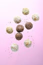 Levitating Vegan Sweets, Delicious Candy Balls with seeds, nuts and dried fruit, Healthy Candies on Pink Background Royalty Free Stock Photo