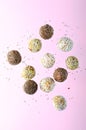 Levitating Vegan Sweets, Delicious Candy Balls with seeds, nuts and dried fruit, Healthy Candies on Pink Background Royalty Free Stock Photo