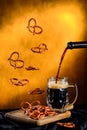 Levitation bretzel with mug of dark beer Royalty Free Stock Photo