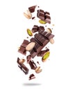 Levitation of crushed dark chocolate bar with pistachios in the air isolated on a white background Royalty Free Stock Photo