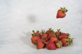 Levitation effect, falling strawberries on light background