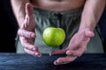 Levitation fresh green apple on a wooden table.