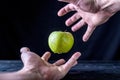 Levitation fresh green apple on a wooden table.