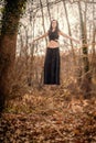 Almost Levitation... Woman standing on a very thin tree`s branch