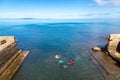 Levuka town, Fiji. Indigenous fijian Melanesian kids are swimming off the embankment, Ovalau island, Fiji, Melanesia, Oceania.