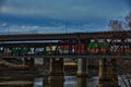 Intermodal railroad infrastructure bridges over the Kansas River from Kaw Point Park with a passing Freight Train