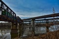 Intersecting Intermodal railroad infrastructure bridges over the Kansas River from Kaw Point Park with a passing Freight Train