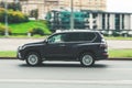 Lexus GX 460 car moving on the street. Full-size japan SUV in motion on city highway