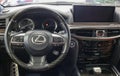 Lexus LX 570 III steering wheel and dashboard. Black leather interior of the SUV. The modern interior of a premium SUV.