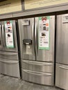 A LG, Samsung, and Whirlpool stainless steel french door refrigerators on sale at a Home Depot Store Royalty Free Stock Photo