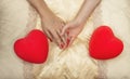 LGBT concept. Women holding hands on the bed with two hearts Royalty Free Stock Photo