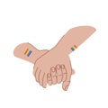 LGBT couple are holding hands. LGBT love concept. Hands with lgbt flags tattoos. Hold hands