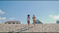 Lgbt couple running beach in bikini. Happy girls spending summer at ocean shore Royalty Free Stock Photo