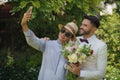 LGBT gay friends with bouquet selfie together in gay wedding ceremony Royalty Free Stock Photo