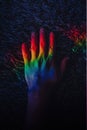 LGBT pride. Gay rights. Peace freedom. Diversity harmony. Graceful woman hands in blur rainbow lights. Iridescent blue red green