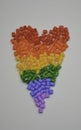 LGBT rainbow flag made with children`s plastic hama beads pieces on a white background