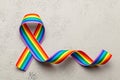 LGBT rainbow ribbon pride symbol. Stop homophobia. Grey background