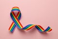 LGBT rainbow ribbon pride symbol. Stop homophobia. Pink background