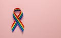 LGBT rainbow ribbon pride tape symbol. Stop homophobia. Pink background. Copy space for text.