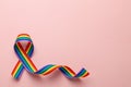 LGBT rainbow ribbon pride tape symbol. Stop homophobia. Pink background. Copy space for text.