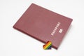 Lgbt rights and searching for asylum and migration concept, and rainbow gay pride symbol heart and red passport on white Royalty Free Stock Photo