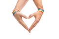 Male hands with gay pride wristbands showing heart Royalty Free Stock Photo