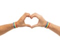 Male hands with gay pride wristbands showing heart Royalty Free Stock Photo