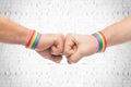 Hands with gay pride wristbands make fist bump Royalty Free Stock Photo