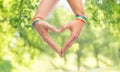 Male hands with gay pride wristbands showing heart Royalty Free Stock Photo