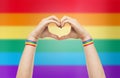 Male hands with gay pride wristbands showing heart Royalty Free Stock Photo