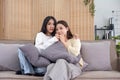 LGBT, Two beautiful scared girls watching horror movie at living room. Royalty Free Stock Photo