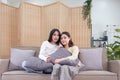 LGBT, Two beautiful scared girls watching horror movie at living room. Royalty Free Stock Photo