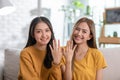 LGBTQ Asian lesbian young couple smiling showing couple wedding rings happiness with love together.Cheerful Homosexual couple