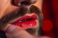 LGBTQ bearded gay man using red lipstick, young LGBT guy applying make-up, closeup, homosexual male trans concept, generative AI