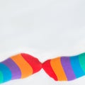 LGBTQ+ community rights. Two left feet wearing multicolored rainbow flag socks, with white background Royalty Free Stock Photo