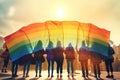 LGBTQ concept. Positive people holding rainbow flag isolated in studio. Pride month. Royalty Free Stock Photo